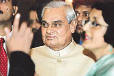 Prime Minister Atal Behari Vajpayee is accompanied by Indias High Commissioner to Malaysia Veena Sikhri (R) after delivering a speech at a hotel in Kuala Lumpur on Wednesday.