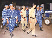Rapid Action Force personnel and policemen patrol a residential area in East Delhi on Sunday following a series of alleged attacks by a monkey-man. The city police has set up a special team to hunt down the shadowy beast.
