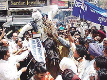 Workers of the District Valmiki Sabha burn an effigy of Mr Harbans Lal Sethi, head of the urban cell of the local unit of the Bharatiya Janata Party, at Ghanta Ghar Chowk, Ludhiana, on Wednesday.