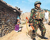A soldier stands guard at Surankot village in Poonch district, 256 km north of Jammu, on Friday.