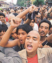 Nepalese youths shout pro-monarch slogans.