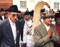 Nepals King Gyanendra (right) walks with Nepals Prime Minister Girija Prasad Koirala at Hanuman Palace in Kathmandu on Monday.