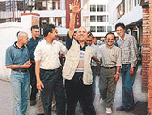 A plainclothes police officer (centre) calls a vehicle after arresting three journalist-publishers of Nepals largest paper Kantipur Daily.