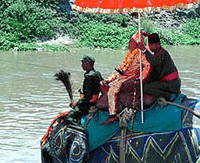 Priest Durga Prasad Sapkota, dressed as the assassinated Nepalese King Birendra, rides an elephant in Kathmandu on Monday.