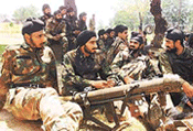 Army soldiers sit in a camp after a gunbattle at Zainakote in Budgam district, 15 km west of Srinagar, on Thursday evening.
