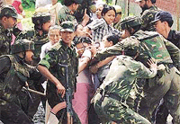 Paramilitary troopers scuffle with residents of Imphal, capital of Manipur, during a four-and-a-half-hour relaxation of curfew on Friday. 