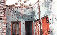 Houses and shops with mortar shell marks in Pallanwala sector.