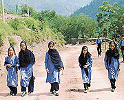 Kashmiri children walk to school along the Indian road which leads to Muzaffarabad in Pakistan, at Lal Pul, 117 km west of Srinagar. 
