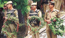 Policemen take wreaths to be laid on the coffin carrying the body of Deputy Superintendent Parveen Kumar at the Nehru helipad in Srinagar on Saturday.