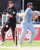 Indian opener Virender Sehwag hits a boundary on his way to a century as New Zealand wicketkeeper Adam Parore looks on during their one-day match in Colombo on Thursday.