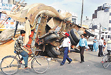 This overloaded and overturned truck becomes a traffic hazard on Jagraon bridge on Sunday.