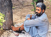 Jagtar Singh chained to a tree at his house in Talwandi Malian, Moga, on Monday. 