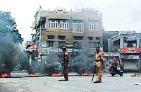 Demonstrators burn tyres and block roads during the Jammu Bandh on Monday.
