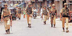 Border Security Force men patrol a street