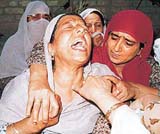 Kashmiri women mourn the killing of two alleged militants on the outskirts of Srinagar on Saturday. 