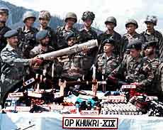 Army officers and jawans at a camp in Panzgam with arms and ammunition recovered from a hideout in Rashanpora-Dardpora forests in Kupwara district
