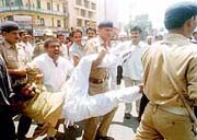 Police personnel arrest NDA activists in Patna on Tuesday during the Bihar bandh.