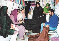 Kashmiri girls looking for burqa cloth in a shop in Srinagar on Sunday.