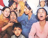 Wailing relatives of Abdul Majeed, a 10-year-old Kashmiri boy, are consoled by other women at the village of Janbazpora, 60 km north of Srinagar. 