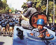 Pakistani policemen in riot gear block a road in Lahore on Thursday, during a demonstration by pro-Taliban supporters.