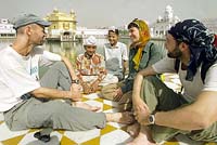 Western tourists sit beside young Sikh boys inside the Golden Temple complex in Amritsar on Thursday. 