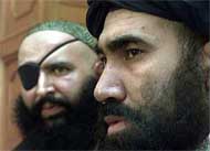 Mullah Abdul Salam Zaeef (right), the Taliban Ambassador to Pakistan, speaks to reporters
