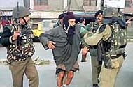 BSF troopers help an injured man