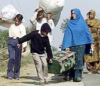 A family evacuates with their belongings after mortar and heavy machinegun fire landed near their border villages in Samba, 40 km south of Jammu, on Friday.