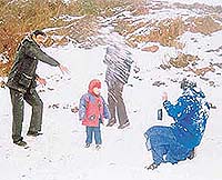 Tourists having fun in the snow at Kufri on Monday.