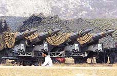 A villager passes by missiles facing the border with Pakistan at an undisclosed location