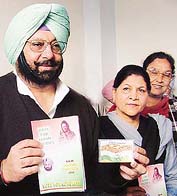 Accompanied by Mrs Sukhbans Kaur Bhinder, the Punjab Congress chief, Capt Amarinder Singh, releases the Congress manifesto