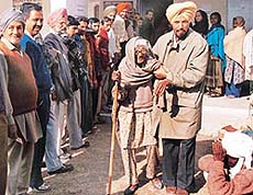 100-year-old Dulari Devi is being taken to a polling booth at Kurali