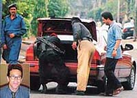 Pakistani policemen search vehicles on a street