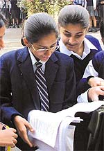 The students of class 10 check the answers after the first day’s examination at Jesus and Mary School on Saturday.