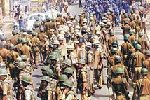 Paramilitary personnel stage a flag march