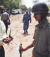 A plainclothesman shows pointed weapons