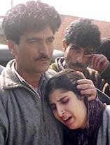 Arifa Bano, the daughter of grenade explosion victim Abdul Ahad, is consoled by relatives