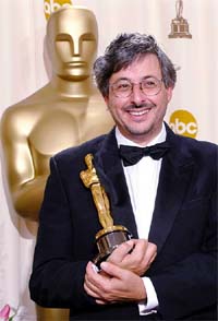 Cinematographer Andrew Lesnie holds the Oscar for Best Cinematography