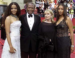 Actor Sydney Poitier poses at the 74th Annual Academy Awards with his wife Joanna and their daughters