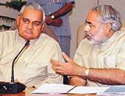 Gujarat Chief Minister Narendra Modi speaks to Prime Minister Atal Behari Vajpayee