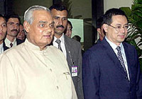 Prime Minister Atal Behari Vajpayee with Mr David T.E. Lim, Acting Minister of Information Communication and Arts, on his arrival at Changi International Airport in Singapore on Sunday.