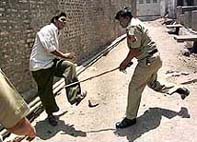 A policeman hits a man 