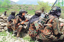Indian soldiers take up positions during search of an area after a gunbattle with militants at Bandipora.