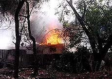 A house goes up in flames during fresh cases of rioting and arson in parts of Ahmedabad on Tuesday.