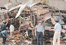 Pakistani officials inspect the ruins of a bus after an explosion in Karachi on Wednesday.