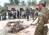 Army men stand by the bodies of three militants at the Kaluchak Army Camp, 16 km south of Jammu, on Tuesday.