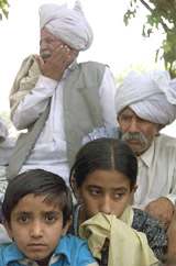 A girl and a boy along with elders leave their village after Pakistan mortar shelling at Chadwal, 70 km south of Jammu, on Thursday.