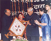 Himachal Pradesh Chief Minister Prem Kumar Dhumal presents a Chamba rumal to Prime Minister