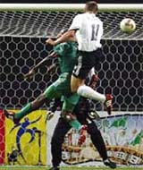 Germanys Miroslav Klose outjumps Saudi Arabias Abdullah Sulaiman Zubromawi to score his second goal during their group E match at the World Cup Finals 
