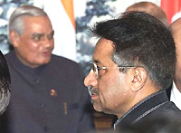 Prime Minister Atal Behari Vajpayee stands in the background as Pakistani President Pervez Musharraf leaves the 16-nation Conference on Interaction and Confidence-Building Measures in Asia, in the Kazakh city of Almaty, on Tuesday.